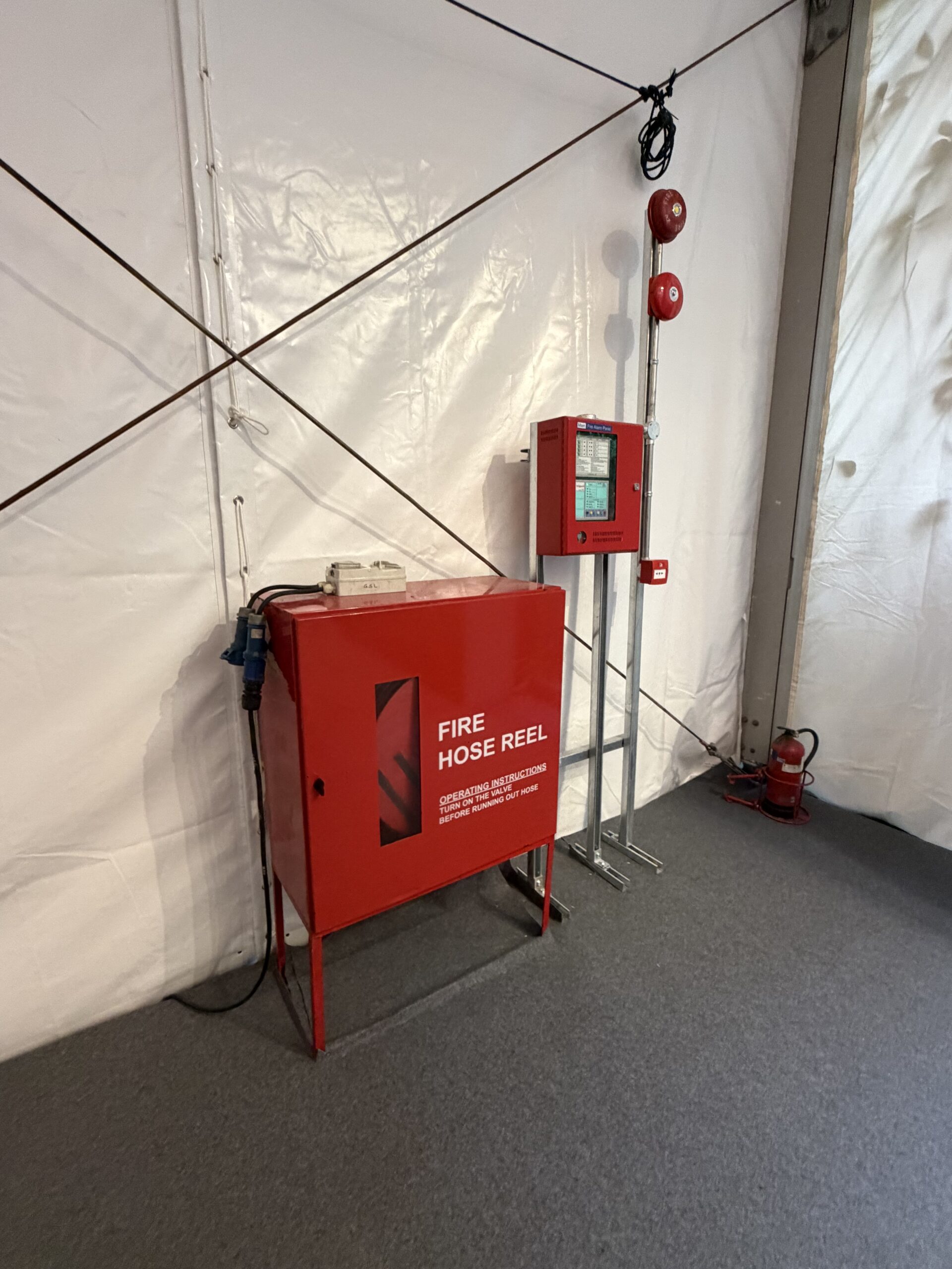 Fire hose reel, alarm equipment and extinguisher installed inside a Singapore Garden Festival event structure
