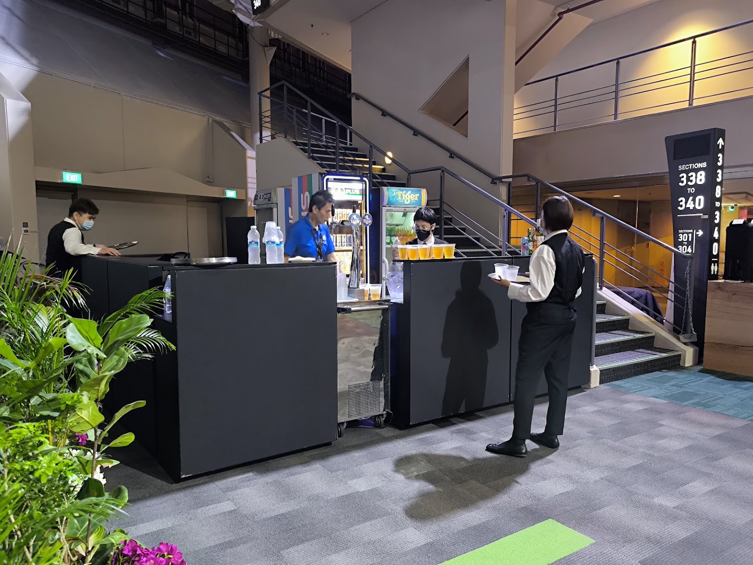 Black bar counters supplied by Nanyang Inc for beverage service inside Singapore Indoor Stadium