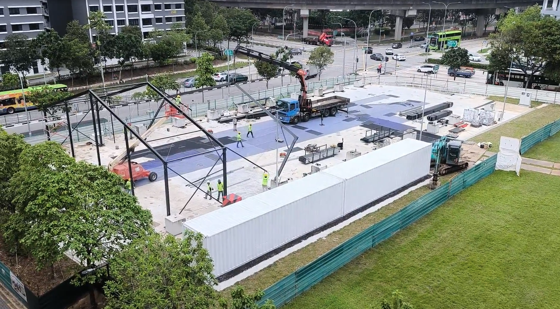Elevated view of the black aluminium A-frame shelter being assembled at PW10 Punggol West