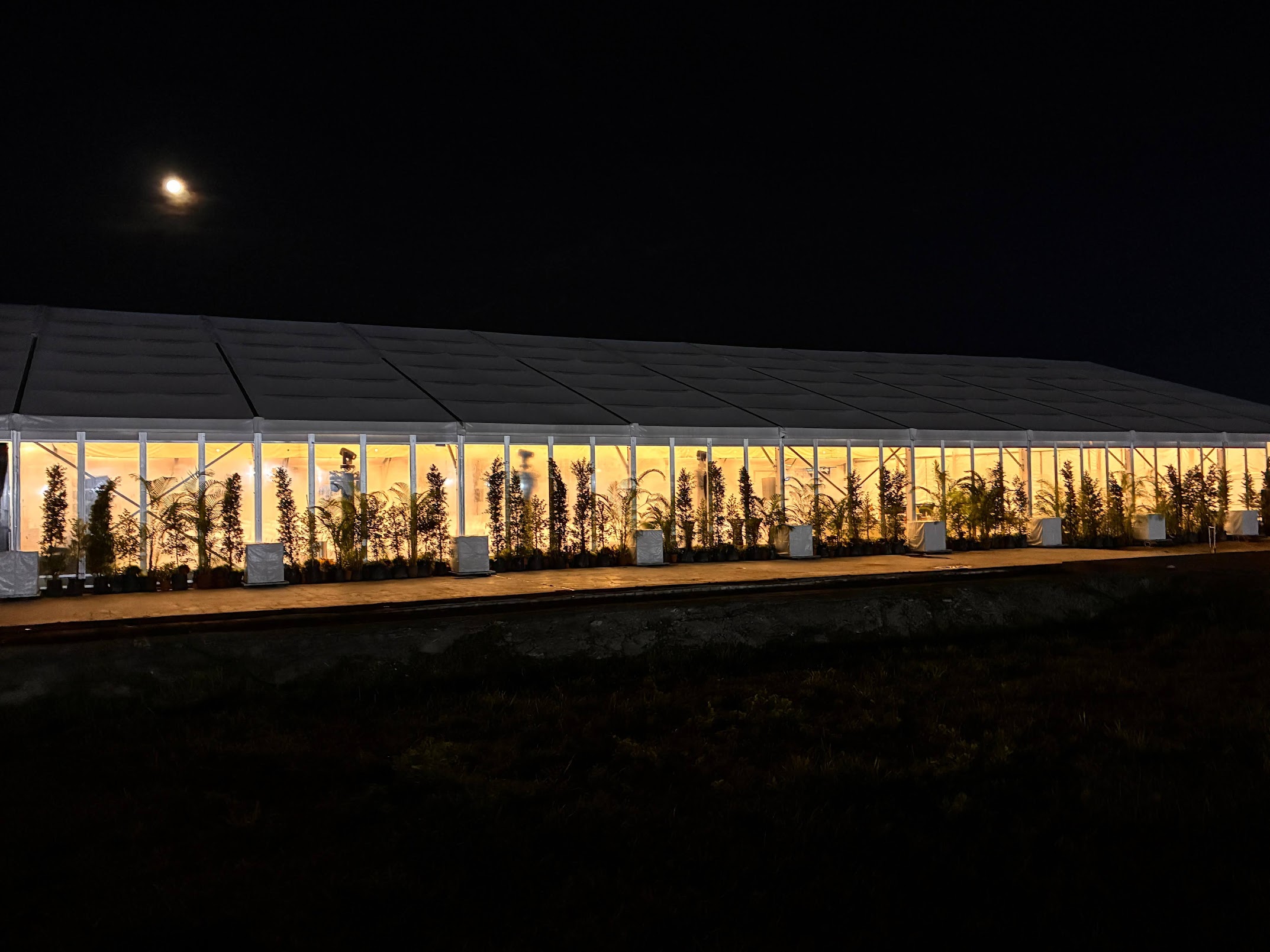 Glass-panelled aluminium marquee illuminated at night for the Changi Airport Terminal 5 groundbreaking